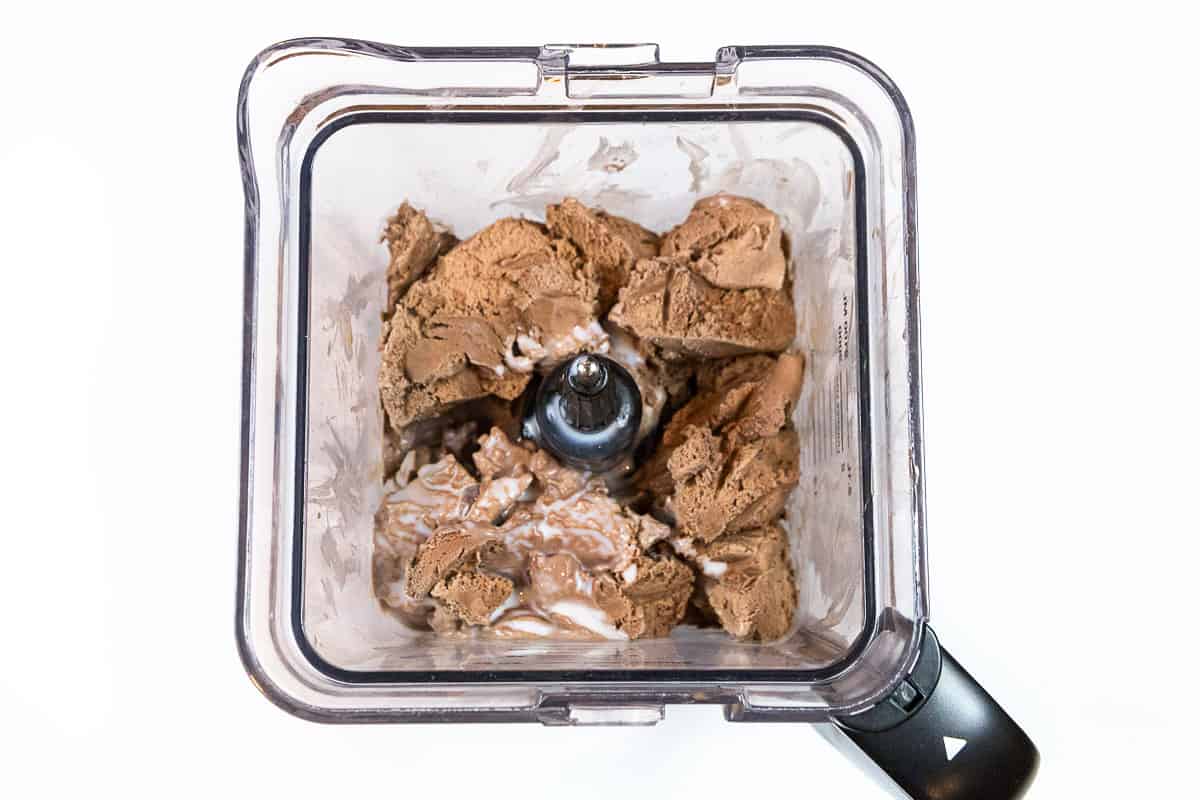 The milk poured on top of the ice cream in the blender.