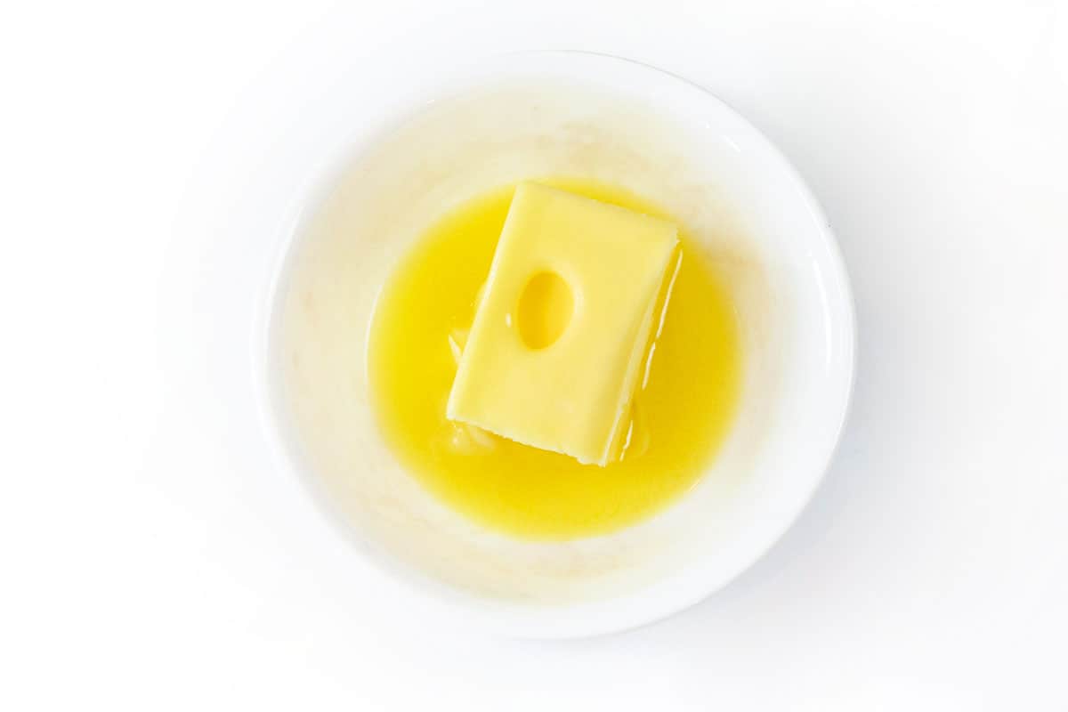 Softened butter from the microwave in a bowl.