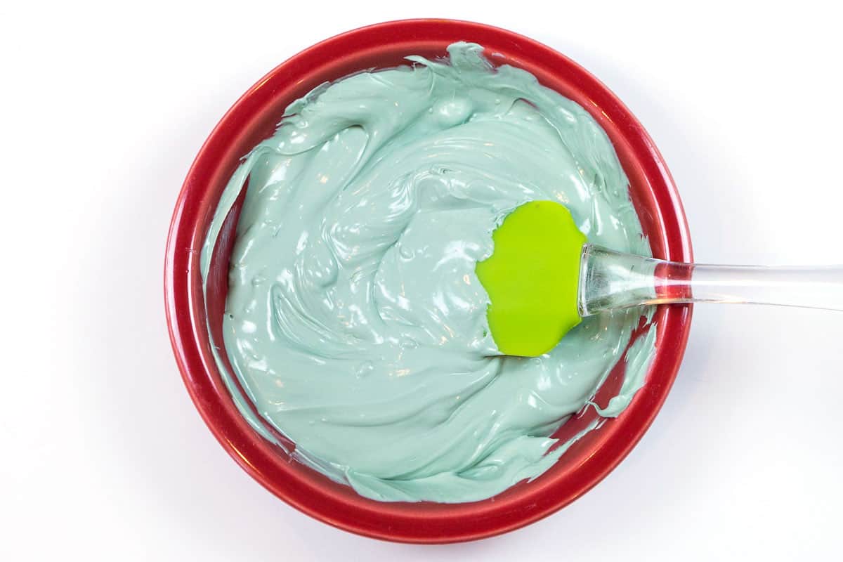 Melted green mint baking chips in a bowl.