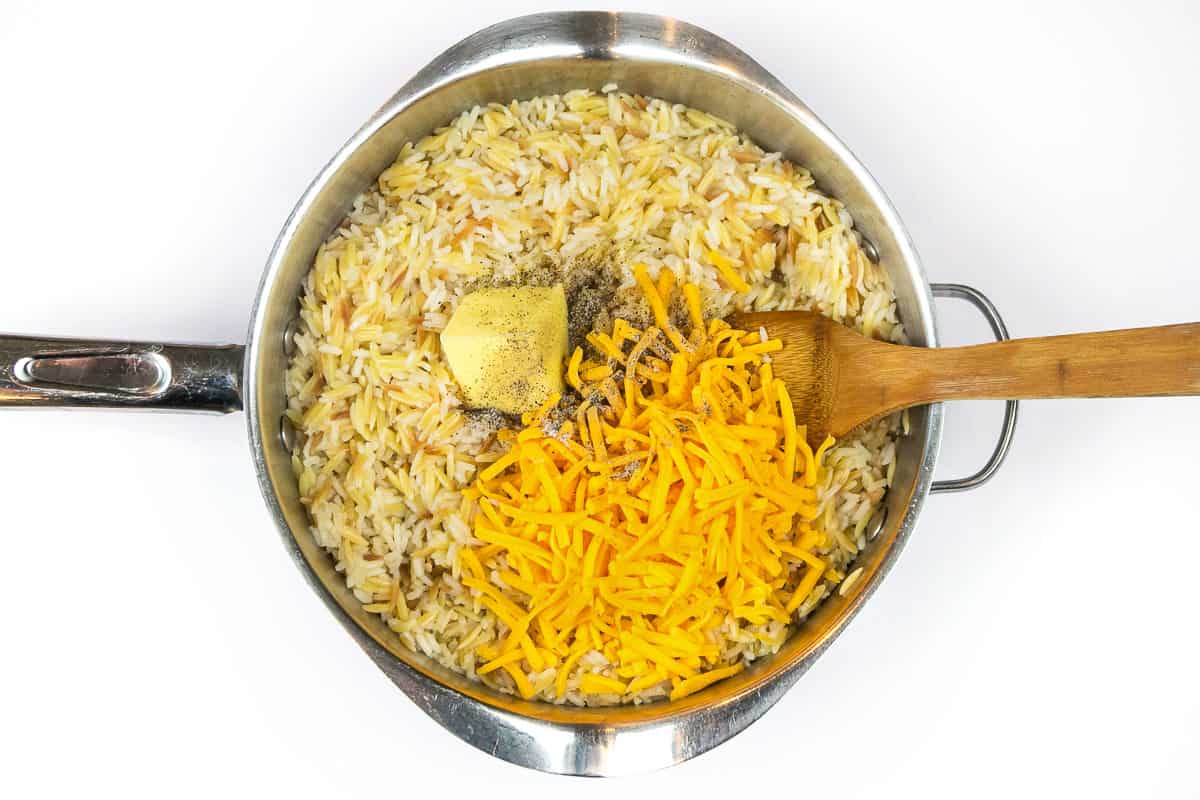 Add the butter, cheddar cheese, salt, and black pepper.