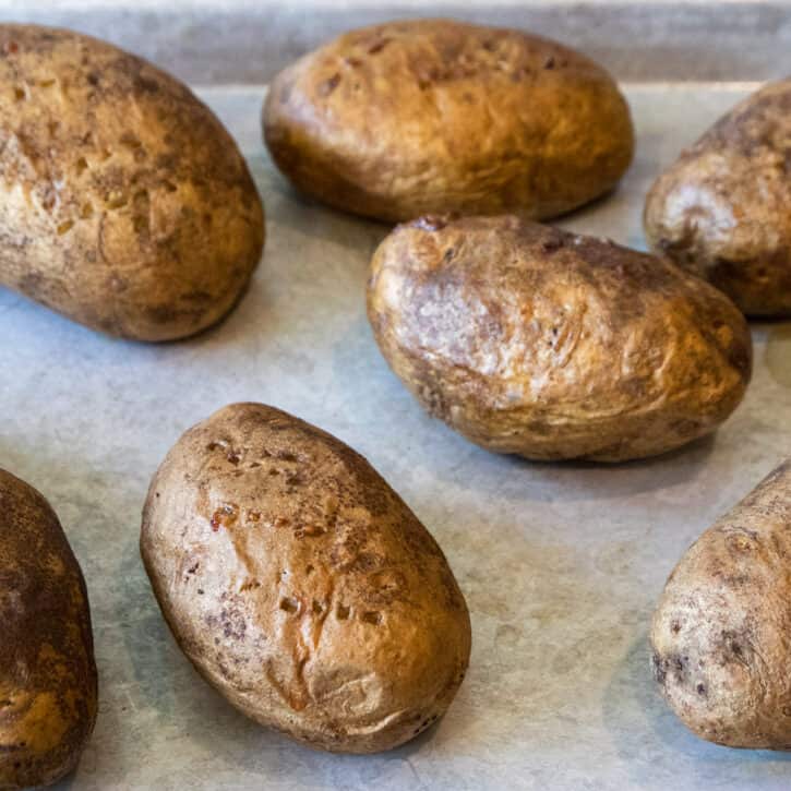 Rub canola oil on the potatoes, then bake the potatoes in the oven at four hundred degrees for one hour.