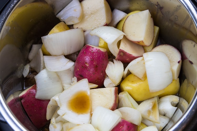 Pour the beef broth mixture over the roast, potatoes, and onions.