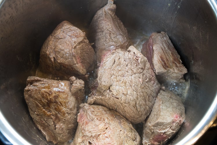 Sauté the chuck roast on all sides until brown. Okay if some pink still showing.