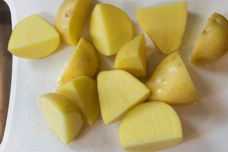 Cut the Yukon gold potatoes in fourths.