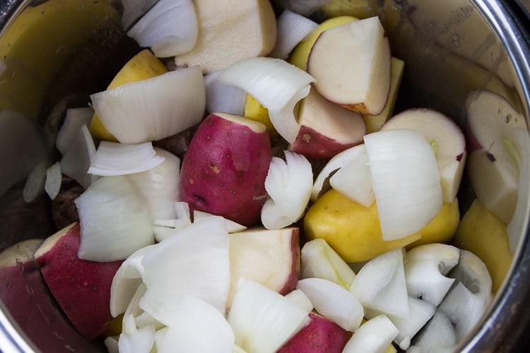 Put the onions on top of the potatoes.