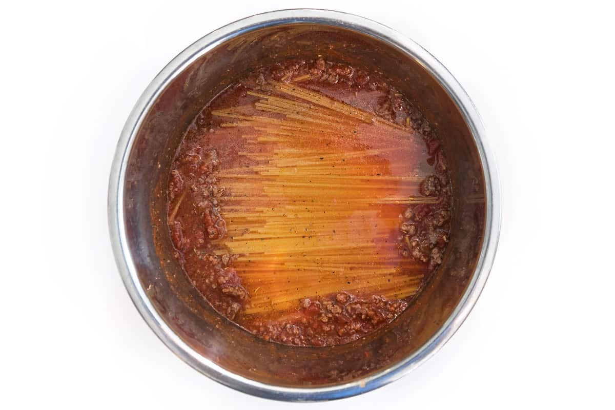 Pour one cup of water over the spaghetti noodles.