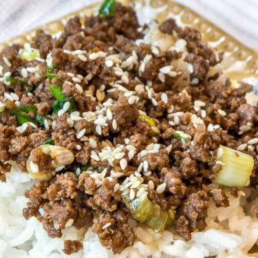 Close up of Korean style ground beef recipe on white rice.