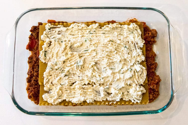 The third layer in the baking dish is the ricotta cheese mixture.
