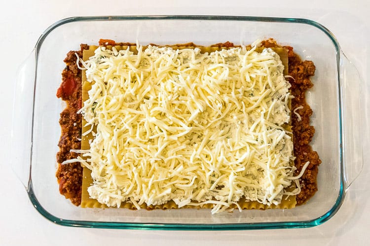 The fourth layer in the baking dish is mozzarella cheese.