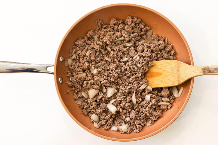 The lean ground beef mixture is done browning with no pink showing.