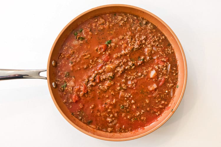 The ground beef mixture is simmering on the stove.