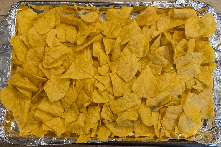 Nachos chips on a sheet pan.