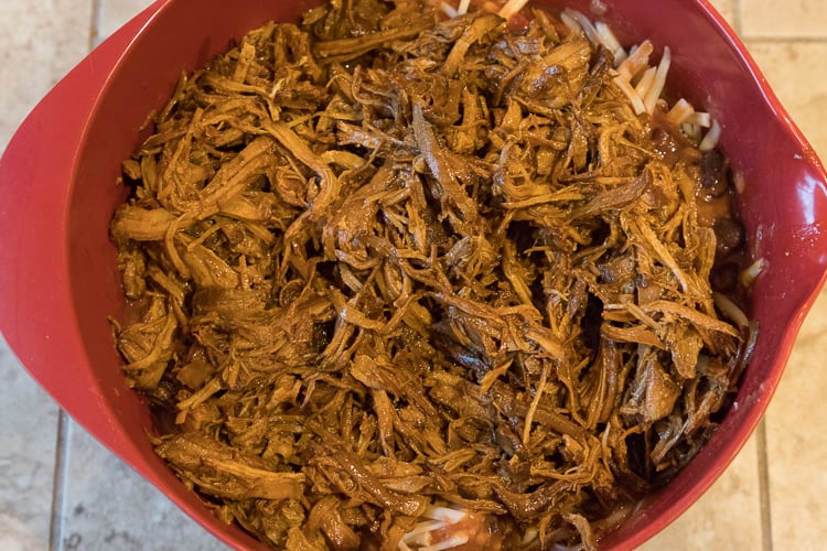 Add the leftover pulled pork to the salsa mixture in the bowl.
