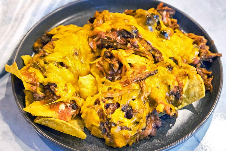 Pulled pork nachos on a plate.