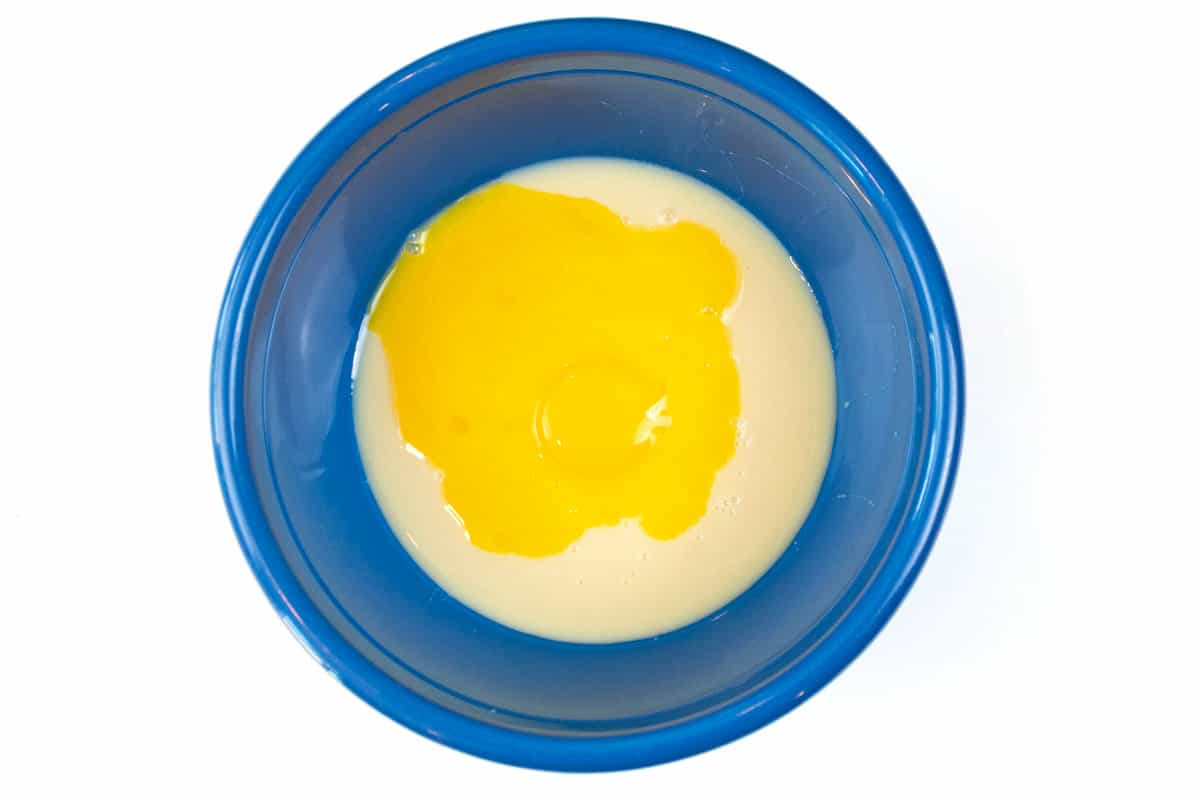 Add the egg yolks with the sweetened condensed milk.