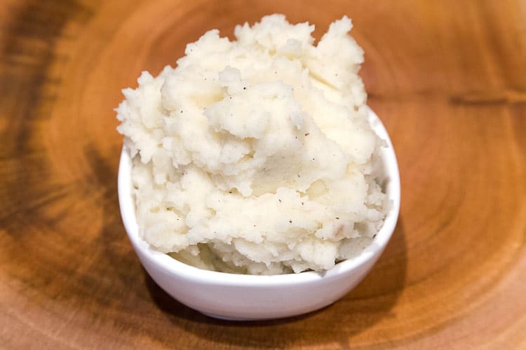 Mashed potatoes close up in a small bowl.