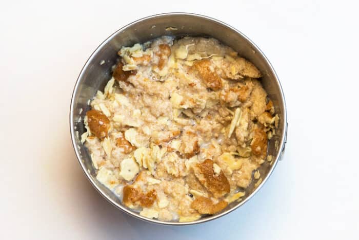 Milk, egg whites, bread crumbs, and crumbled crackers in a bowl.