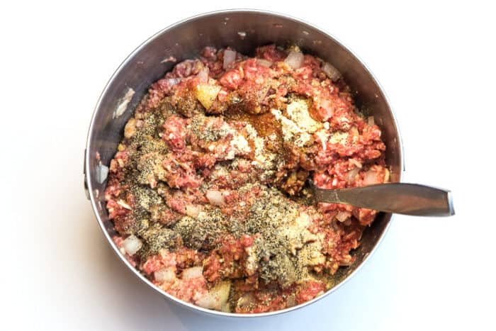 Mix Worcestershire sauce with onion powder, garlic powder, ground mustard, rubbed sage, and black pepper to the lean ground beef mixture.