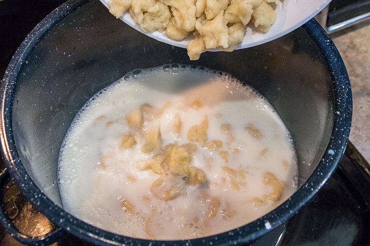 Dumplings are added to the milk and sugar mixture.