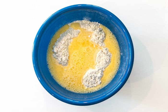 The two beaten eggs and one third cup of water are added to the flour and salt mixture.