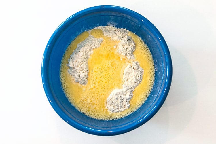 Beaten eggs, water, and flour mixture in a bowl.
