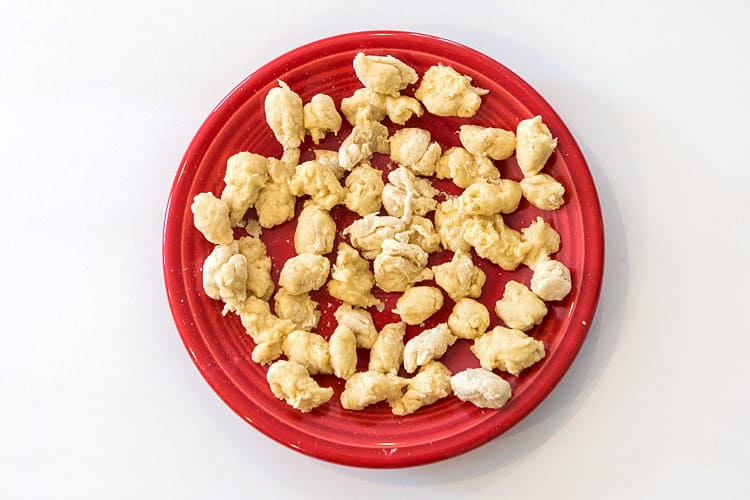 Dumpling dough formed into small round and oblong pieces.