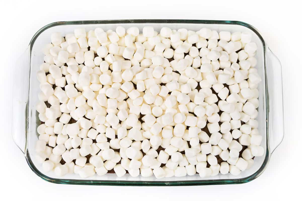 Put five cups of mini marshmallows on top of the cake.