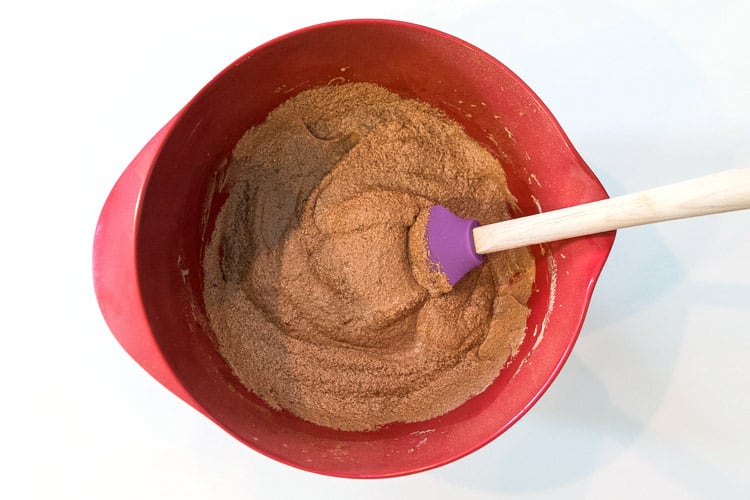 Four eggs and four tablespoons of unsweetened cocoa are mixed with the brown sugar mixture.
