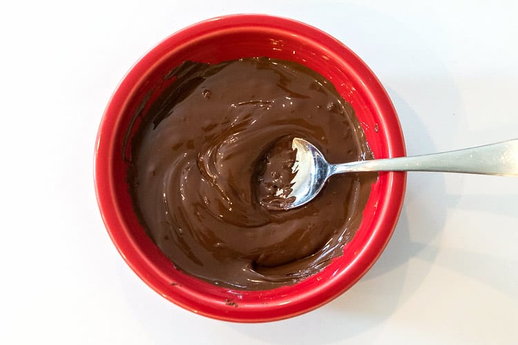 One cup of semi-sweet chocolate chips are melted in the microwave.