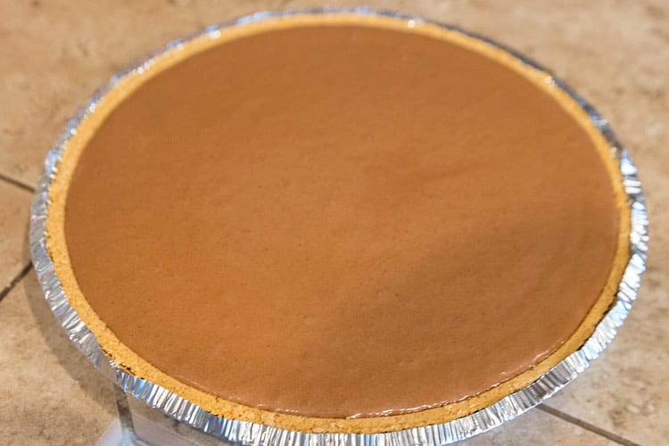 The pie filling is added to graham cracker crust.