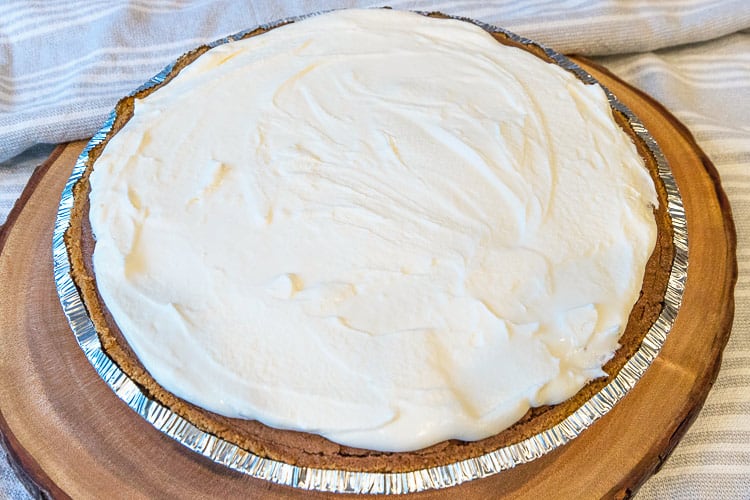 Homemade whipped cream is spread on top of the Mississippi mud pie.