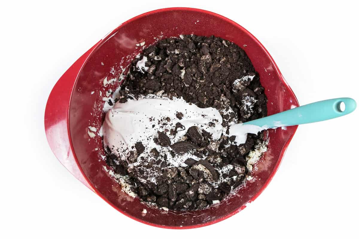 The whipped topping and Oreo crumbs are added to the cream cheese mixture.