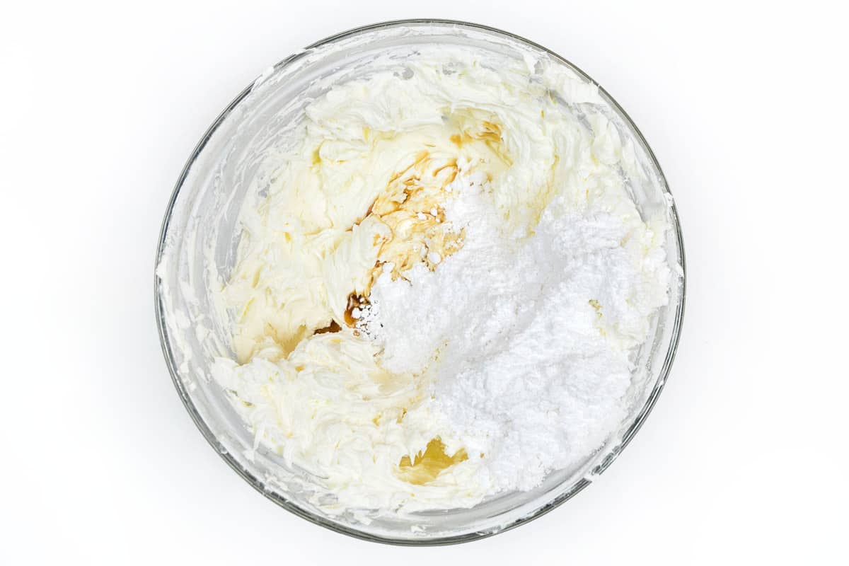 Add the vanilla extract and powdered sugar to the whipped cream cheese.