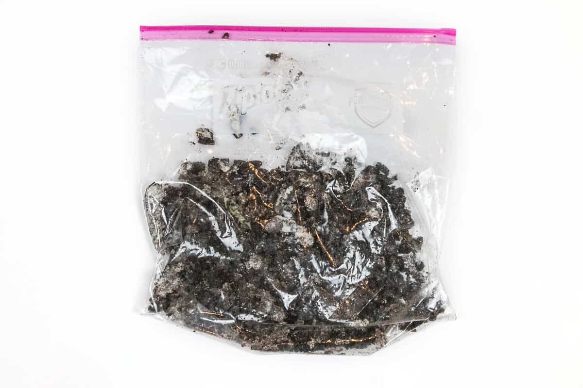 Crushed Oreo cookies in a ziplock bag.