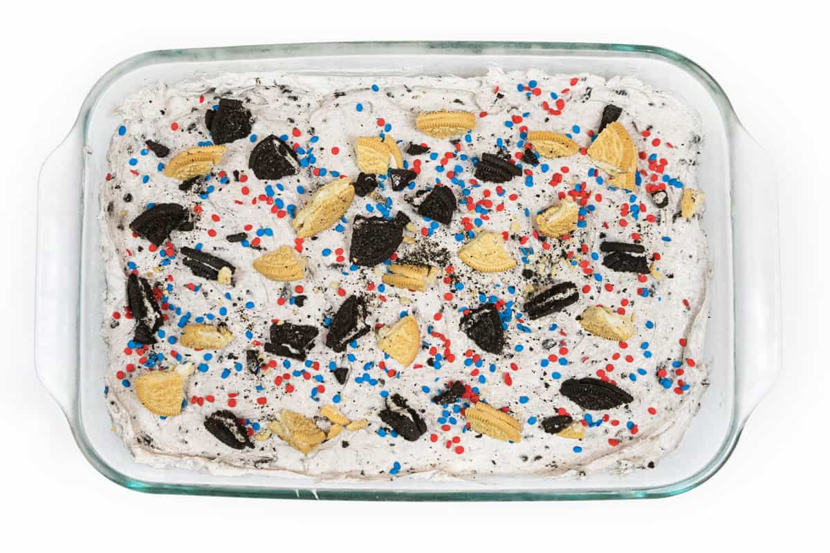 Place the Oreo cookie pieces on top of the sprinkles and cheesecake mixture.