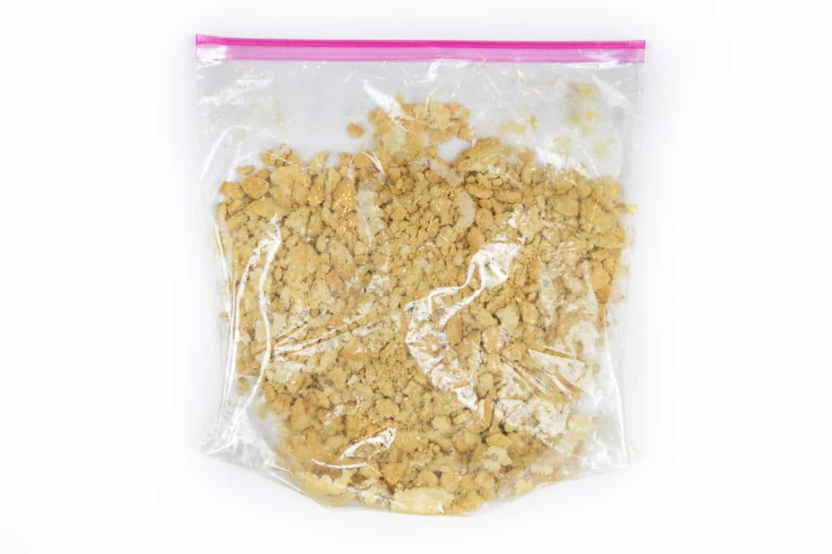 Crushed Oreo golden cookies in a ziplock bag.