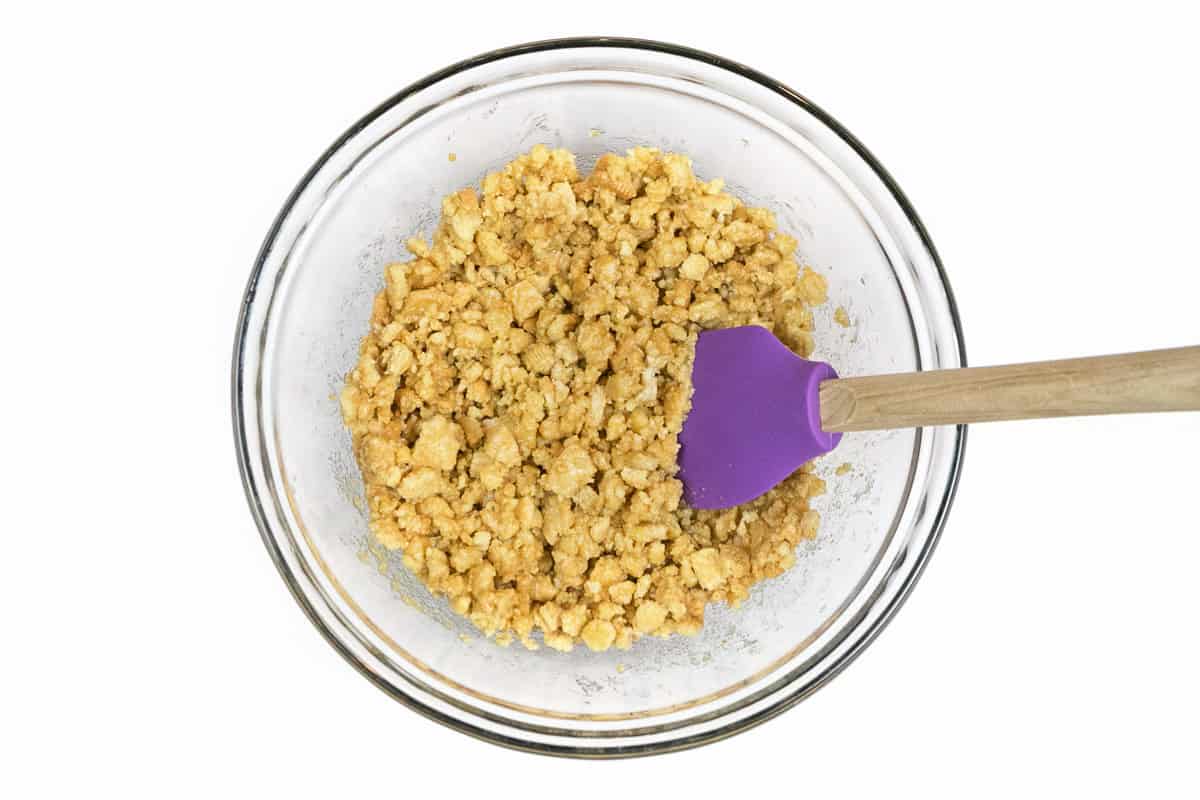 Combine the melted butter and crushed Oreo golden cookies.