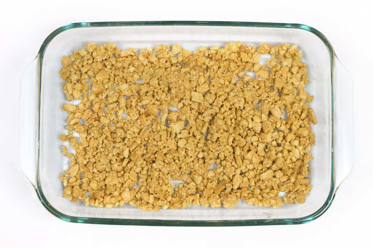 Put the Oreo crust crumbs into a nine by thirteen inch baking dish.