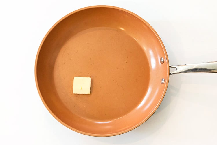 One tablespoon of butter in a frying pan.