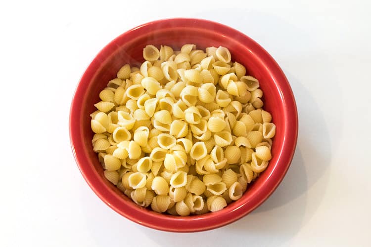 Two cups of cooked pasta noodles in a bowl.