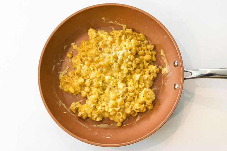 Scrambling the eggs with the pasta noodles.
