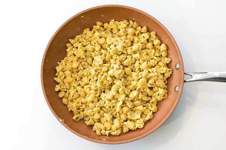 Noodles with scrambled eggs in a frying pan.