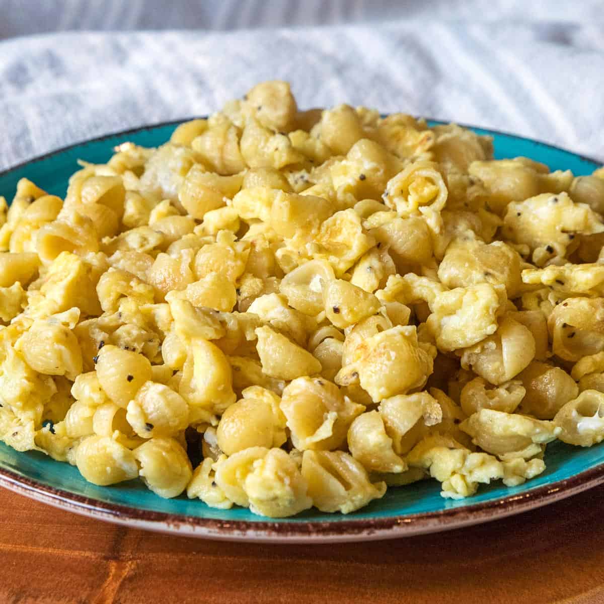 Shell noodles with scrambled eggs on a plate.