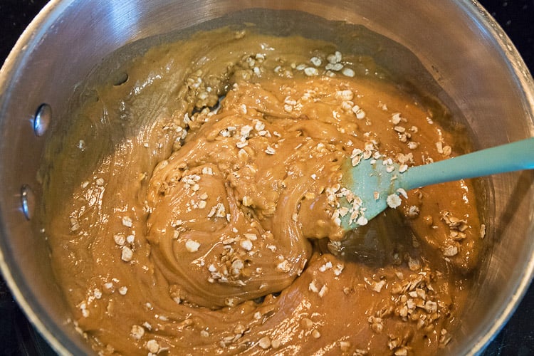 Add half of the rolled oaks to the saucepan. Mix thoroughly.