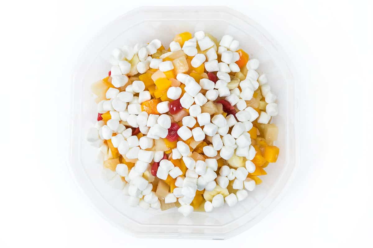 Add the mini marshmallows to the fruit cocktail salad.