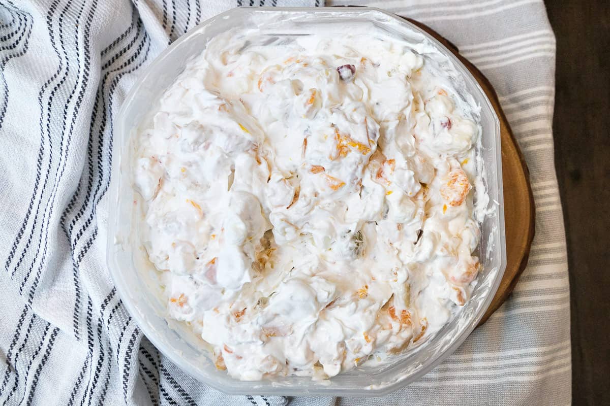 Cool whip thoroughly mixed through the fruit salad.