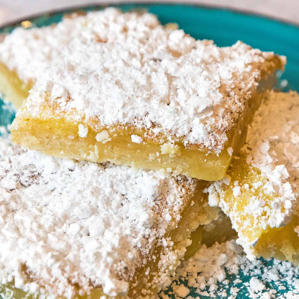 Old fashioned lemon squares on a plate.