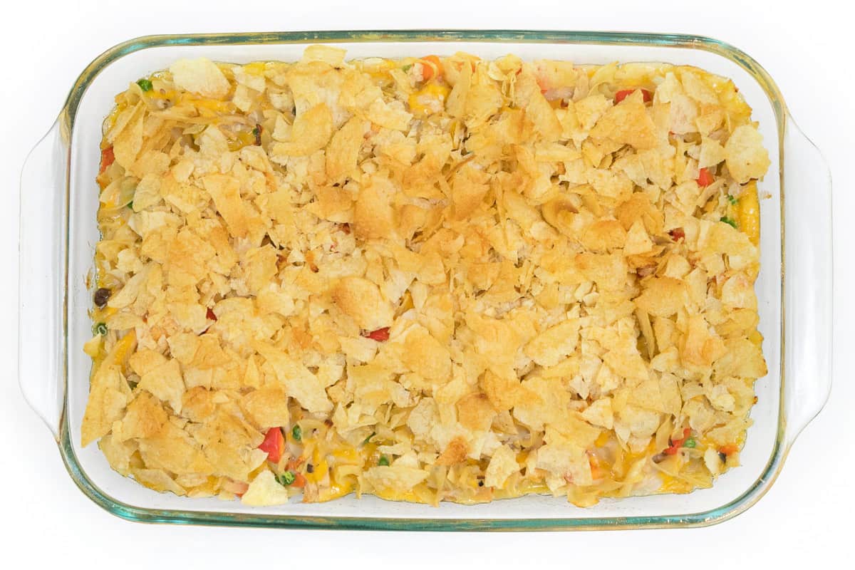 The tuna noodle casserole is baked for fifteen more minutes until the potato chips are golden brown.
