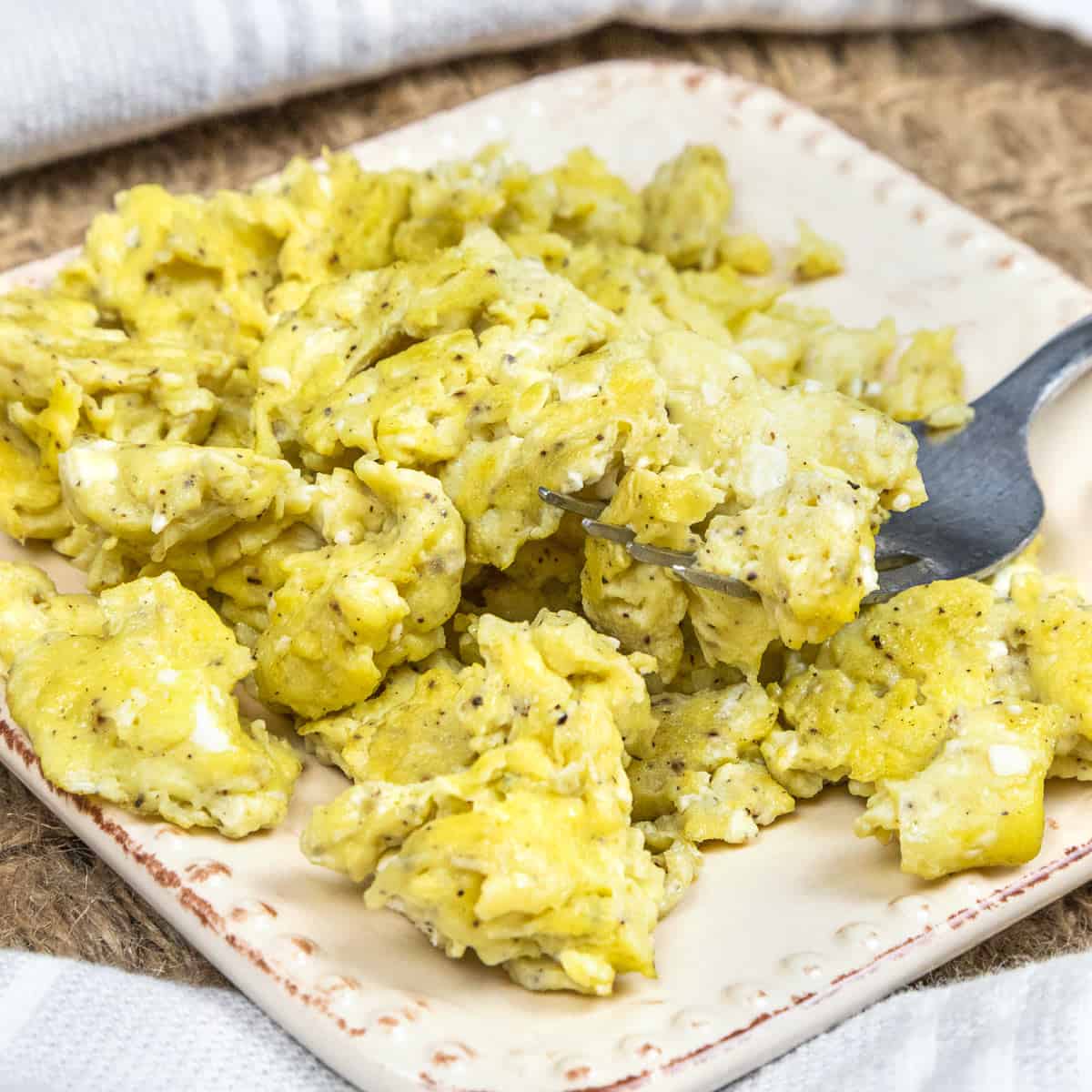 Olive oil scrambled eggs on a plate.