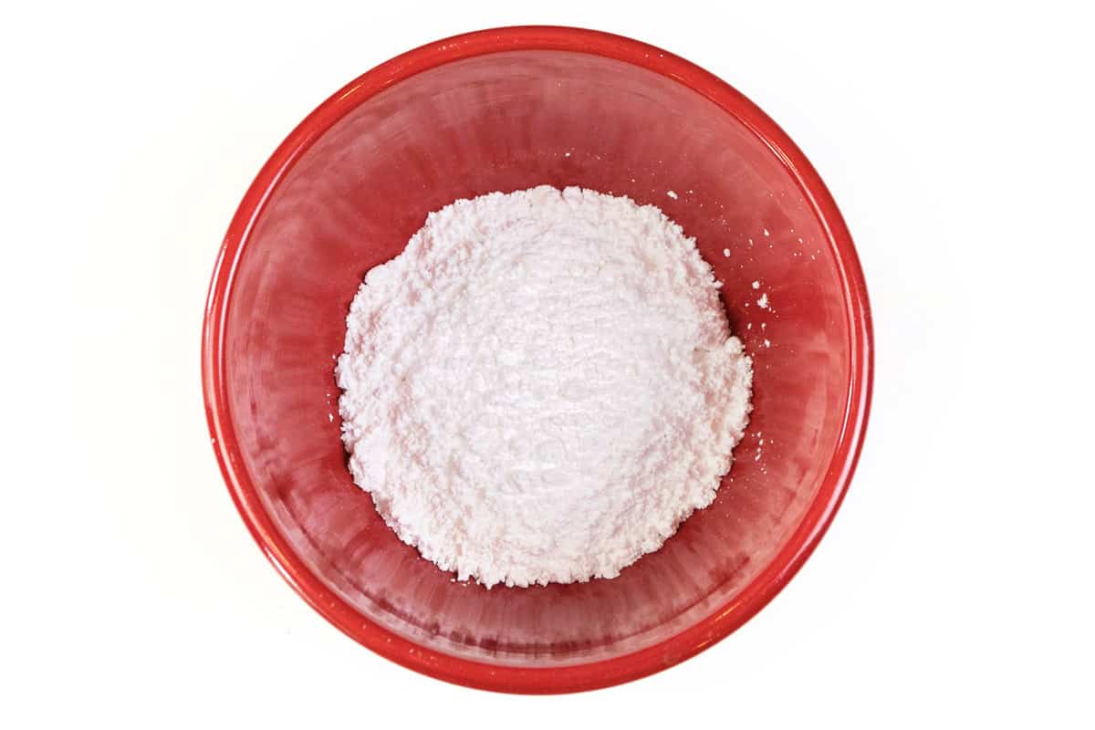 One cup of powdered sugar in a bowl.
